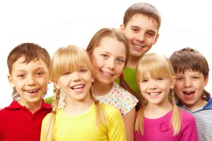 Image of young boys and girls smiling at camera