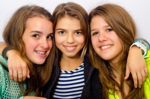 Three happy teenage girls having fun.
